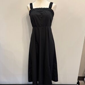 Black dress. Cinches in the back with buttons. Straps tighten with bow in back.